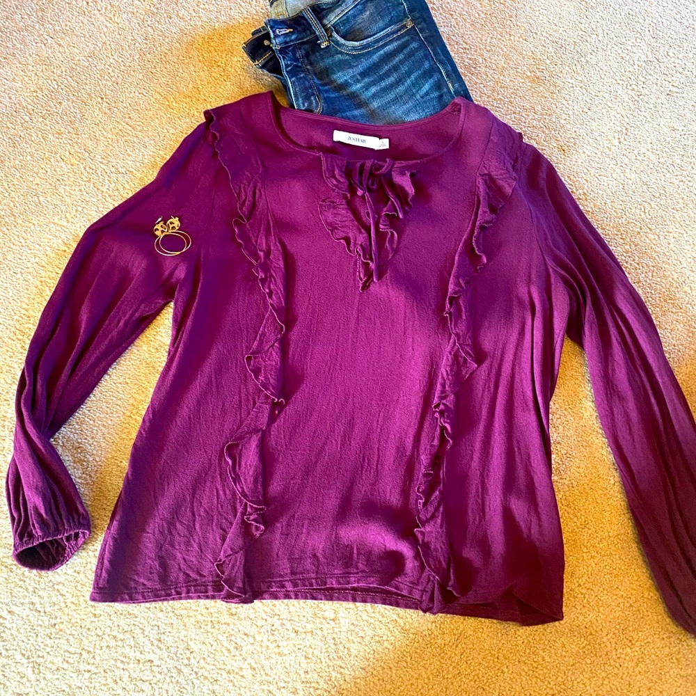 Beautiful blouse with ruffles and tie down the front.